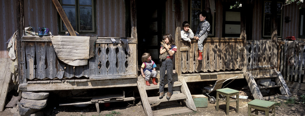 Children play on the veranda of their house in Danesti, Szekely region of Transylvania Romania. 2001. Hasselblad Xpan and 45mm lens